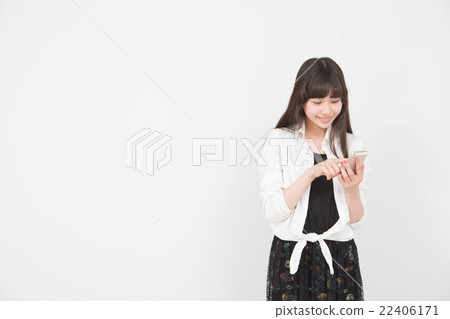 A woman operating a smartphone A woman operating a smartphone 22406171