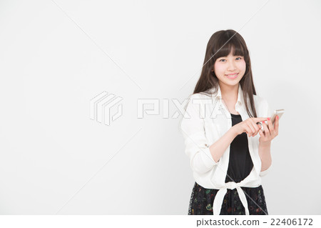 A woman operating a smartphone A woman operating a smartphone 22406172