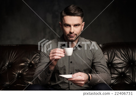 Well-groomed man posing on dark background. 22406731
