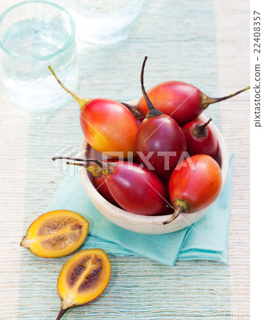 Tamarillo fruits with slice on blue napkin Tamarillo fruits with slice on blue napkin 22408357
