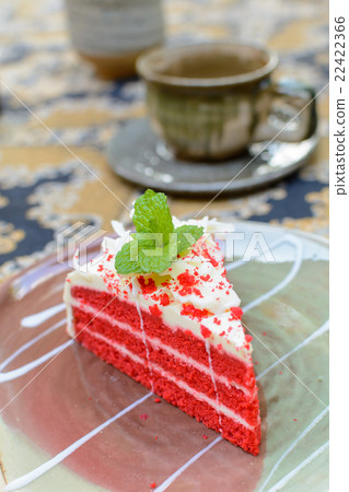 Red velvet cake with cup of tea and kettle 22422366