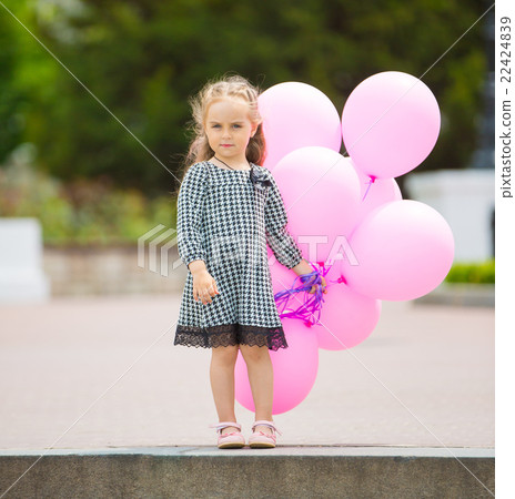 Little girl holding pink balloons Little girl holding pink balloons 22424839