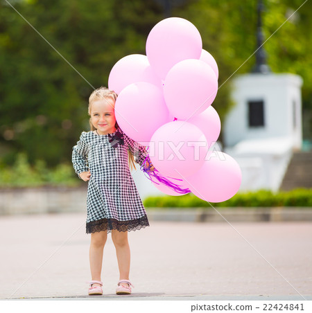 Little girl holding pink balloons Little girl holding pink balloons 22424841