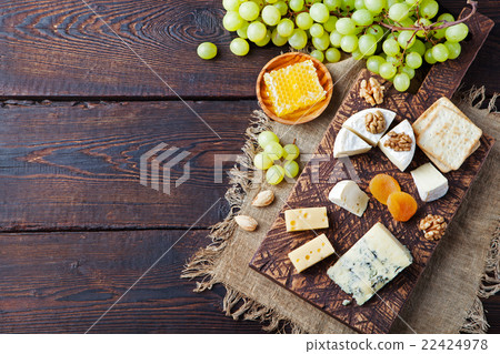 Assortment of cheese with honey, nuts and grape Assortment of cheese with honey, nuts and grape 22424978
