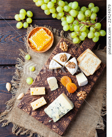 Assortment of cheese with honey, nuts and grape Assortment of cheese with honey, nuts and grape 22424979