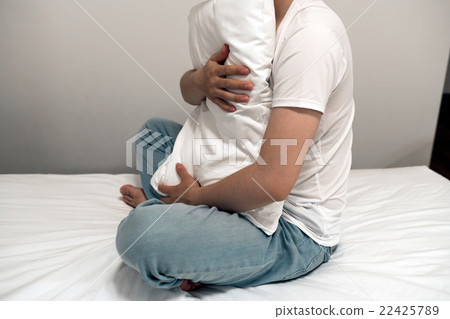 A man holding a pillow A man holding a pillow 22425789
