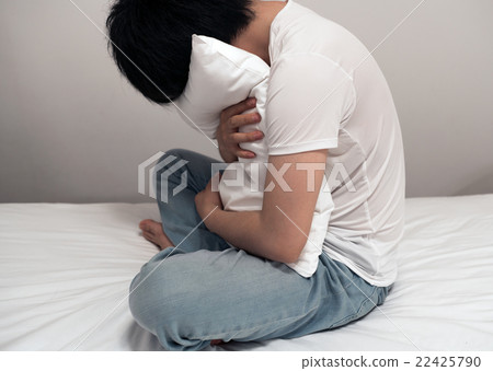 A man holding a pillow A man holding a pillow 22425790