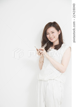Woman using a smartphone Woman using a smartphone 22428040