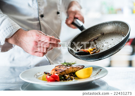 Chef finishing food in his restaurant kitchen 22431273