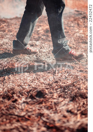Legs of the person extinguish fire. Legs of the person extinguish fire. 22432472