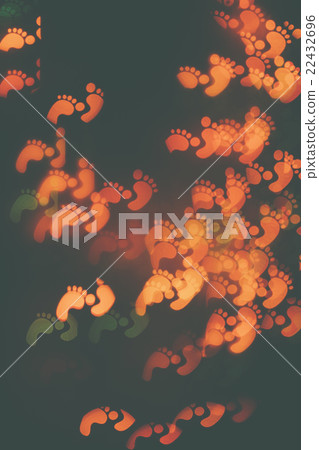 Many orange traces of feet on a dark background. 22432696