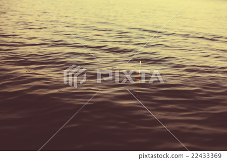 Water and bobber at evening. Water and bobber at evening. 22433369