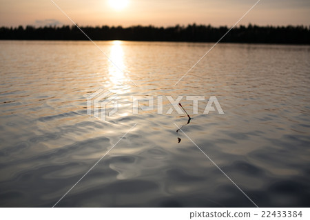 Water and bobber at evening. 22433384