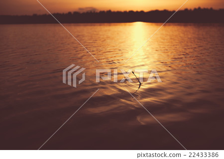 Water and bobber at evening. 22433386
