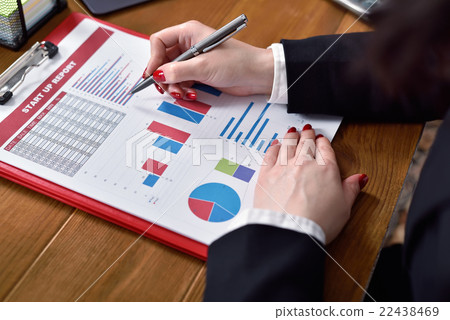 businesswoman checks report businesswoman checks report 22438469