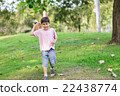 Little sibling boy playing plane paper in the park 22438774