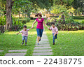 mother running in the park with sons 22438775