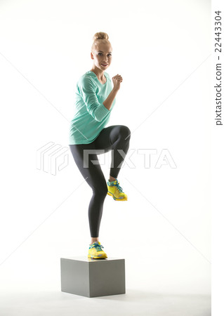 Blonde sports girl on cube  22443304