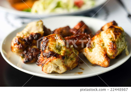 fried slices of meat on the grill 22448987