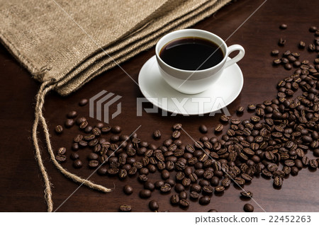 Coffee beans and jacket classic placed to surround a coffee saucer Coffee beans and jacket classic placed to surround a coffee saucer 22452263