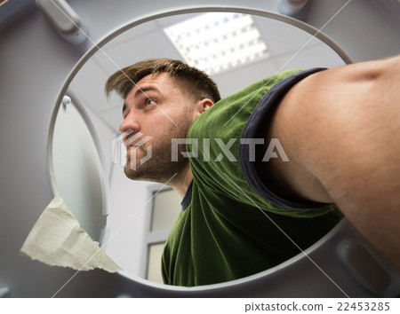 Man with hand in the toilet Man with hand in the toilet 22453285