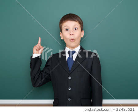 school boy in black suit on green chalkboard 22453521