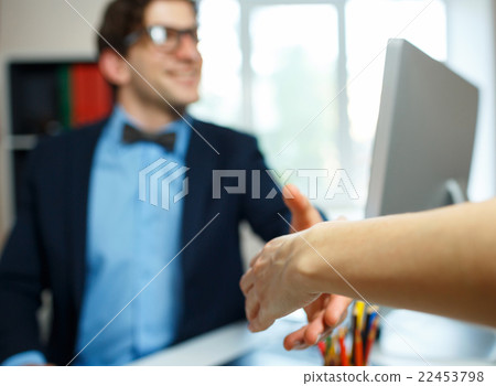 Modern business man with arm extended to handshake Modern business man with arm extended to handshake 22453798