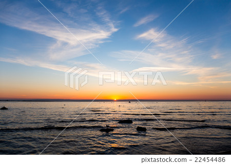 Bright sky and water at sunset 22454486