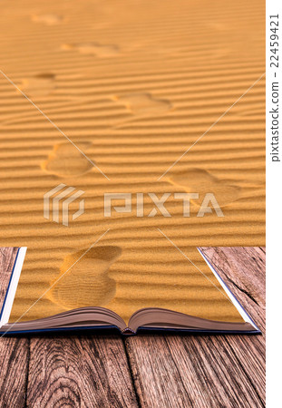 Open book image of Footprints on the sand waves as background Open book image of Footprints on the sand waves as background 22459421