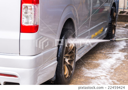 Van Car wash by high pressure cleaners, focus on the car's wheel 22459424