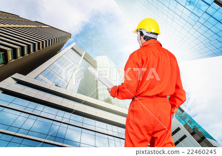 Portrait of Asian engineers holding at the blueprint on Modern business building glass of skyscrapers, Business concept of architecture industrial concept 22460245