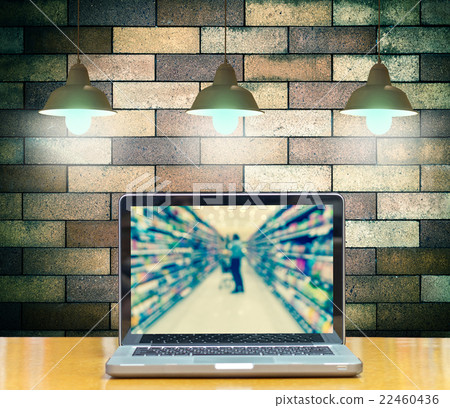 Computer notebook on brick wall background with Luxury lighting decoration show Abstract blurred photo of store bokeh background, online shopping concept Computer notebook on brick wall background with Luxury lighting decoration show Abstract blurred photo of store bokeh background, online shopping concept 22460436