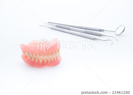 Denture and dental tools,dental mirror on white  22461280
