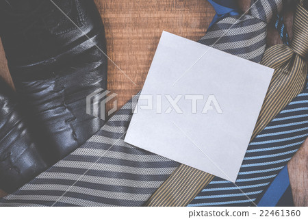 Necktie and shoes on grunge wood background 22461360