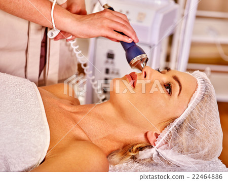 Young woman receiving electric facial massage. Young woman receiving electric facial massage. 22464886