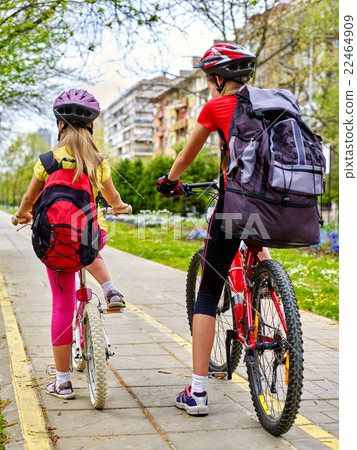 Girls children cycling on yellow bike lane. 22464909