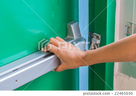 Hand is opening the emergency fire exit door 22465030