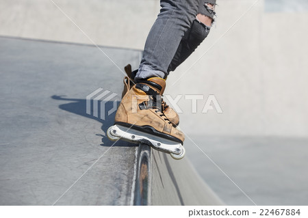 Aggressive inline rollerblader grinding skatepark Aggressive inline rollerblader grinding skatepark 22467884