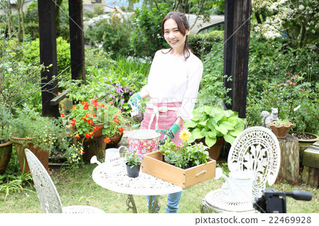 A woman working in a garden A woman working in a garden 22469928