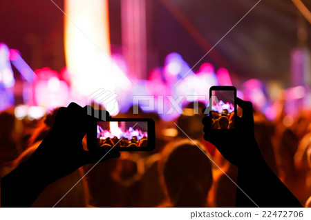Take photo crowd in front of concert stage blurred 22472706