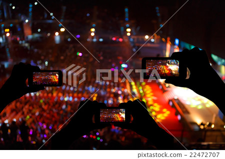 Take photo crowd in front of concert stage blurred 22472707