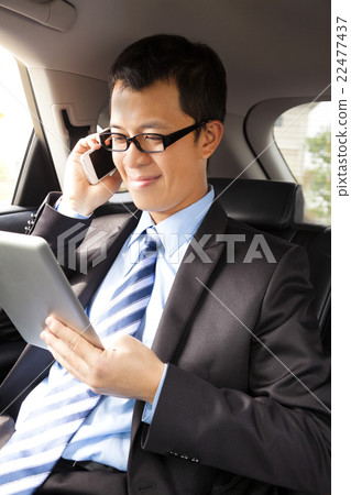 businessman talking with cell phone in the car 22477437