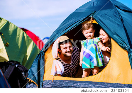 Young couple with their baby daughter in tent Young couple with their baby daughter in tent 22483504
