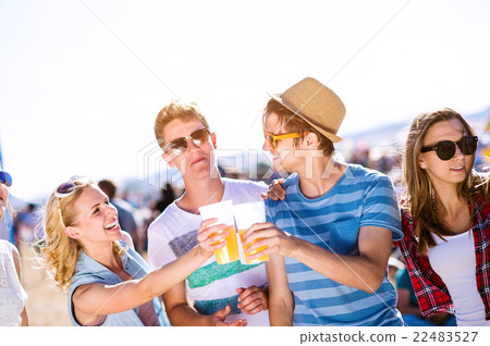 Group of teenagers at summer music festival, sunny Group of teenagers at summer music festival, sunny 22483527