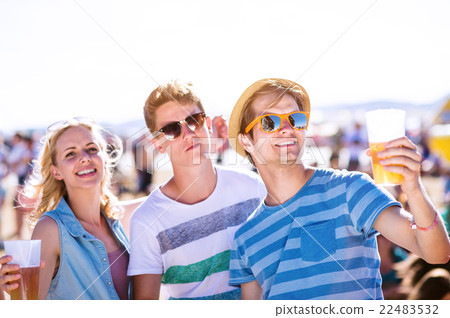 Group of teenagers at summer music festival, sunny Group of teenagers at summer music festival, sunny 22483532