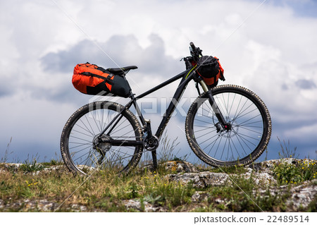 Bicycle with orange bags for travel 22489514
