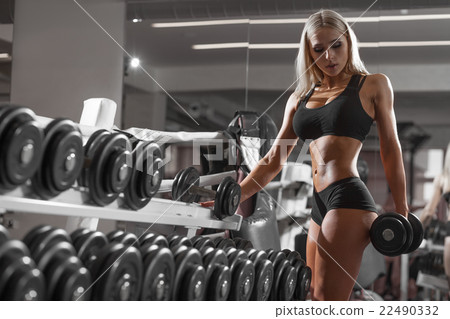 athletic young blondy doing exercise in the gym 22490332
