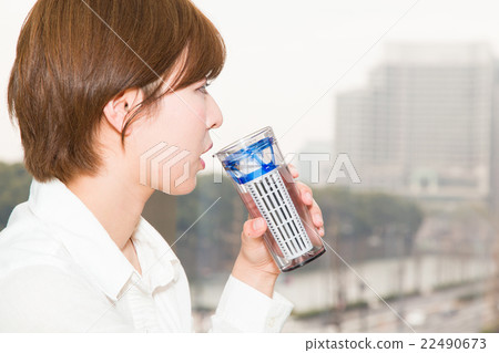 A woman drinking water with a tumbler 22490673