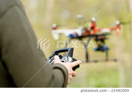 Man controling a drone. 22492009