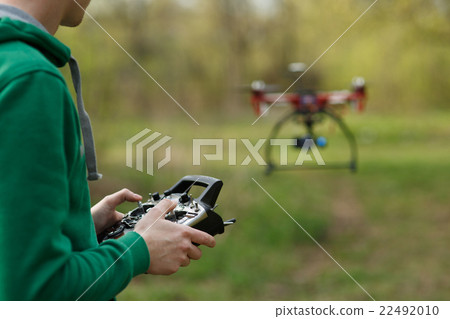 Man controling a drone. 22492010